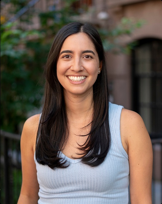 Claudia Maisch, LCSW, smiling outside a New York City brownstone
